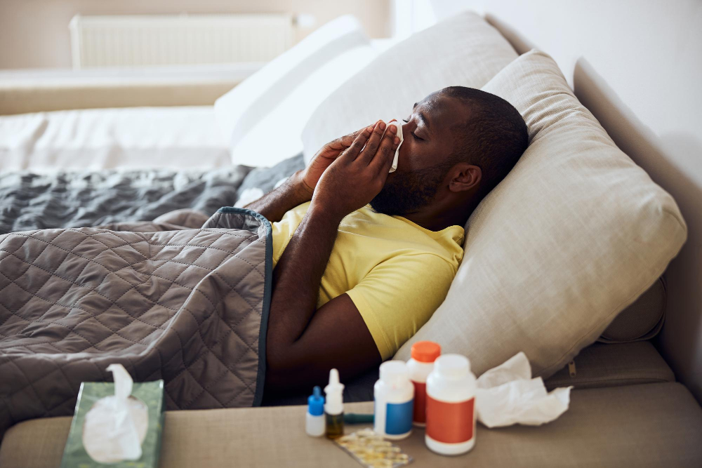 sick-person-blowing-his-nose-lying-bed